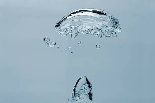 air-bubbles rising in the water, isolated over blue