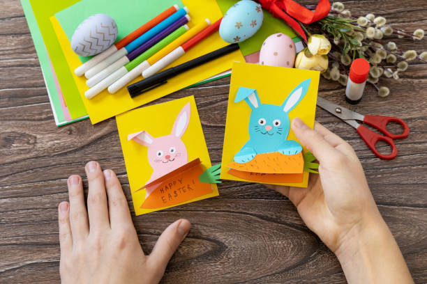 istock A child is holding an Easter congratulation card with Easter bunny. Handmade. Project of children's creativity, handicrafts, crafts for kids. 1458544866