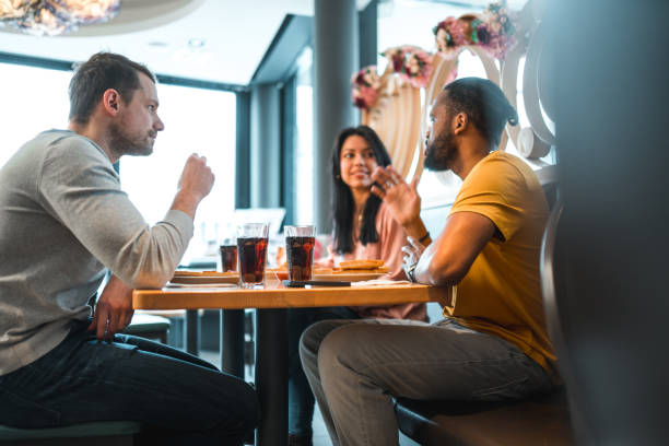 istock Multi-Cultural Group Of People In A Bar Eating Pizza 1458547497
