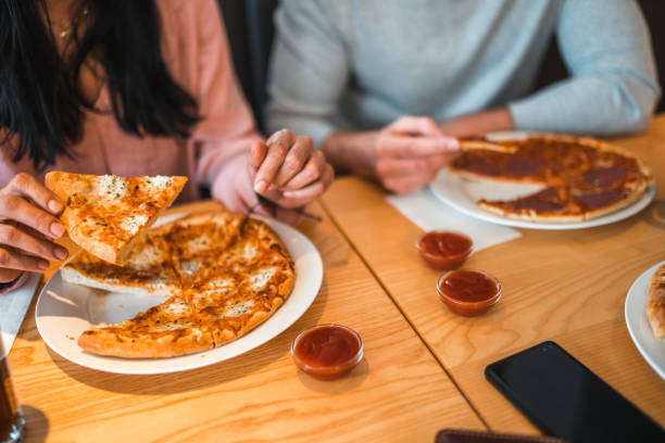 istock Diverse Friends Gathering In A Pizza Place 1458547581