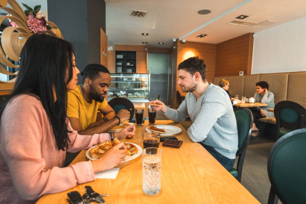 istock Diverse Friends Eating Pizza And Drinking Soft Drinks 1458547622