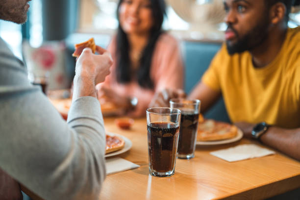 istock Multi-Cultural Group Of People In A Bar Eating Pizza 1458547670