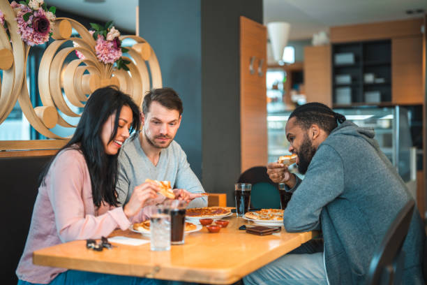 istock Diverse Friends Eating Pizza And Drinking Soft Drinks 1458547788