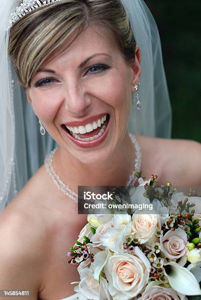 Bride Laughing With Bouquet Of Flowers Stock Photo - Download Image Now - Beautiful People, Beauty, Bouquet