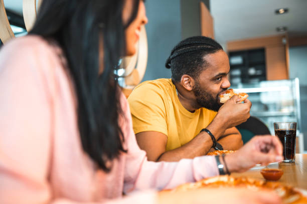 istock Diverse Friends Hanging Out Eating Pizza 1458548242