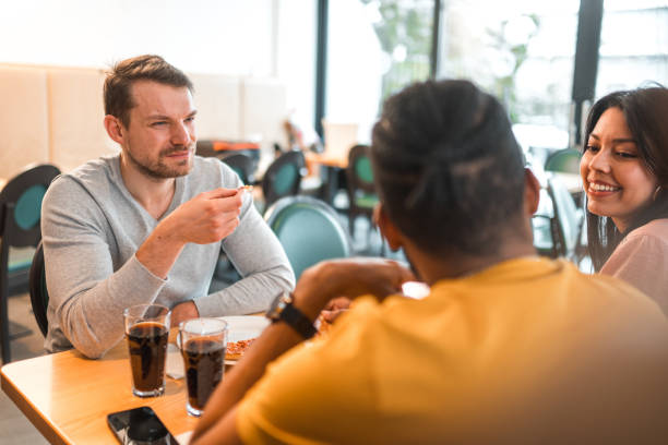 istock Diverse Friends Hanging Out Eating Pizza 1458548269
