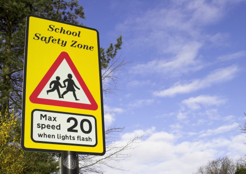 A school safety zone roadside warning sign