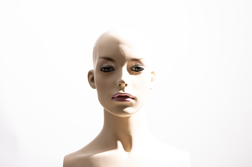 Portrait of a female mannequin on a bright white background, which could be the representation of a human or a machine
