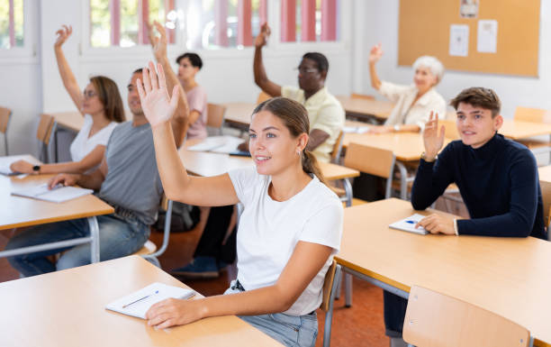 istock Young woman student raising her hand and smiling 1458551712