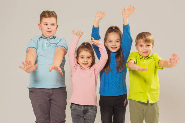 istock Two boys and two girls in studio on white background 1458558461