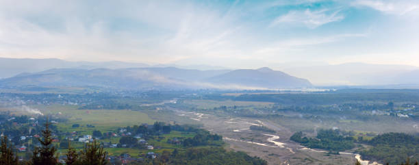 istock Summer misty morning mountain village panorama (countryside landscape). 1458558576
