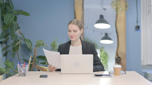 istock Businesswoman Working on Laptop and Documents 1458558752