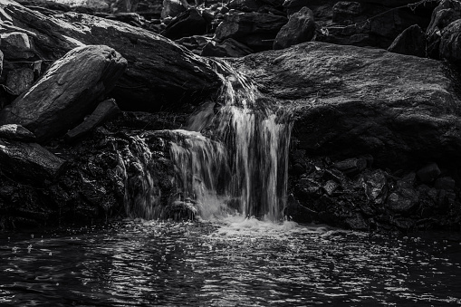 Water flows over rock creating nature themed background.