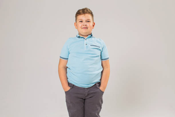 Boy in studio on white background Childhood. Boys overweight boy stock pictures, royalty-free photos & images
