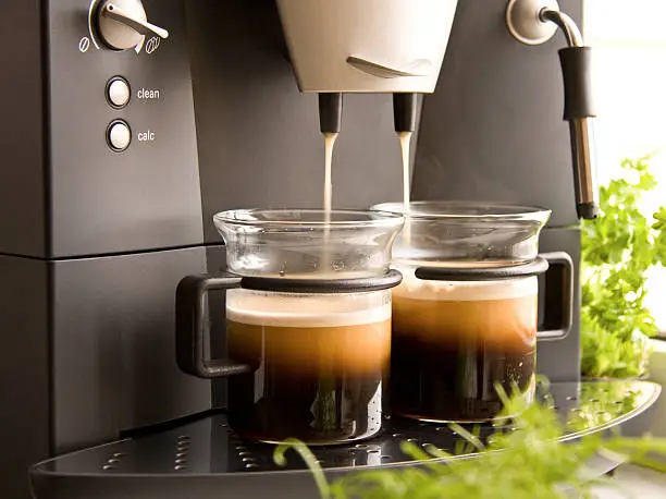 Two cups of fresh coffee with foam made with a coffee machine