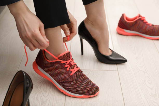 istock Woman changing shoes in office, closeup view 1458564493