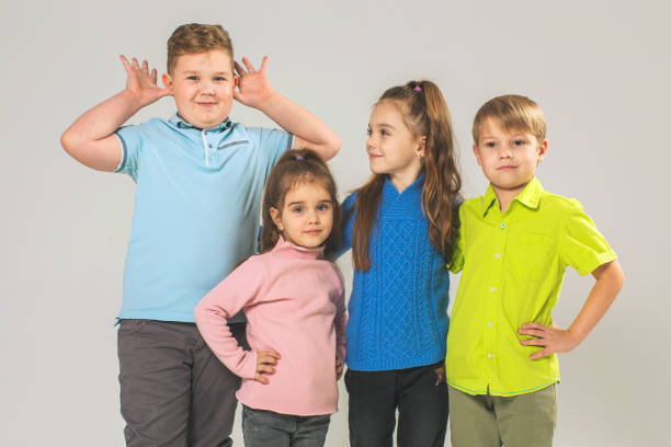istock Two boys and two girls in studio on white background 1458564888