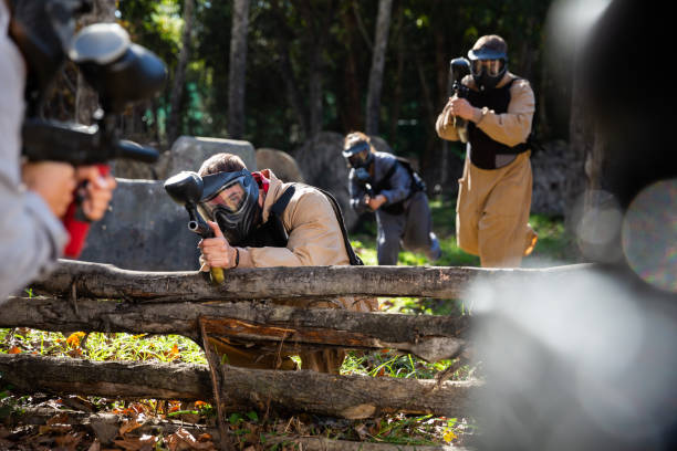 istock Paintball players aiming outdoors 1458565727