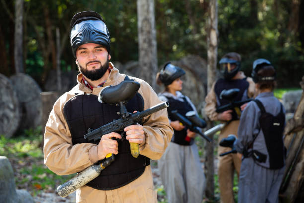 istock Man and his paintball sport team 1458565749