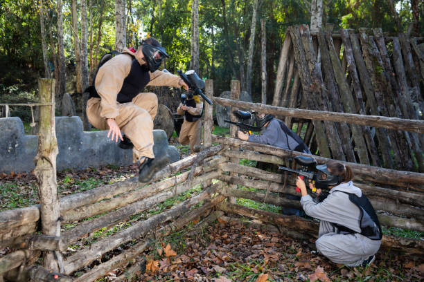 istock People playing paintball outdoors 1458565767