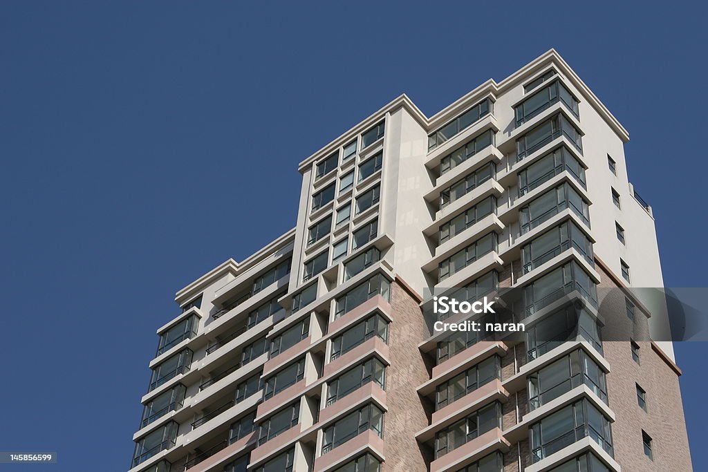 apartment building under clear blue sky new apartment building under clear blue sky Abstract Stock Photo