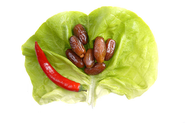 Red pepper,  dates and lettuce background stock photo