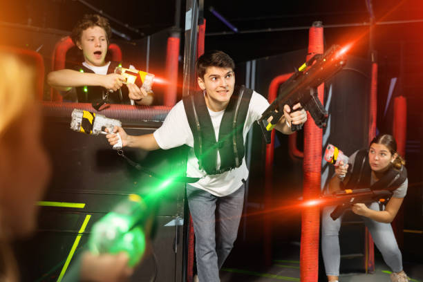 istock Three people having fun playing lasertag in arena 1458568543