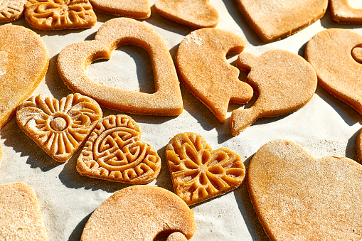 Valentines day background with cookies in shape of heart. Homemade cookies in form of hearts. Holiday festive cookies.