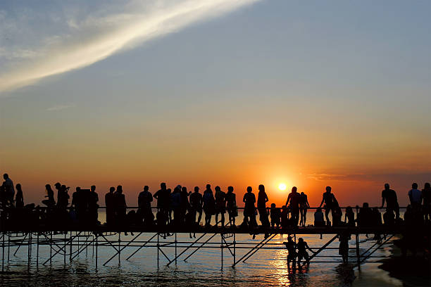 istock young people meeting sunset on sky background 145857176