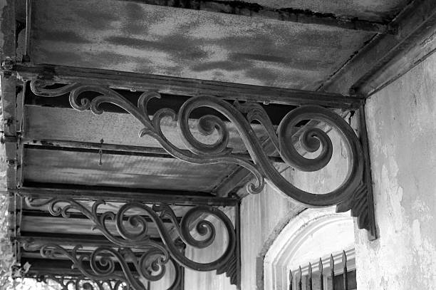 Scrolling wrought iron corbels beneath a balcony in Savannah stock photo