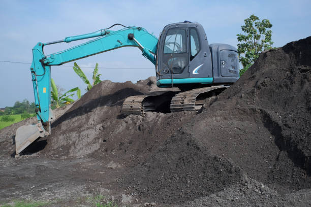istock Mini excavator parked on a sand dune in an industrial area 1458572364