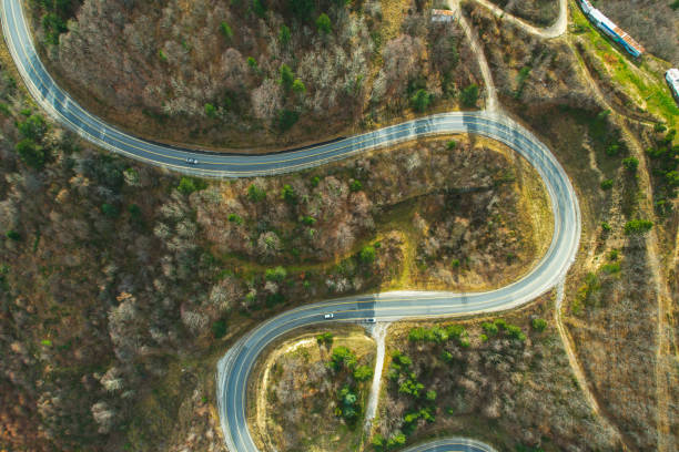 istock winding mountain road in wooded area with trees. ecological way 1458573733