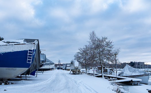 Finland city of Lahti. Winter parking of personal boats and boats, the coastal part of the city and the pier.