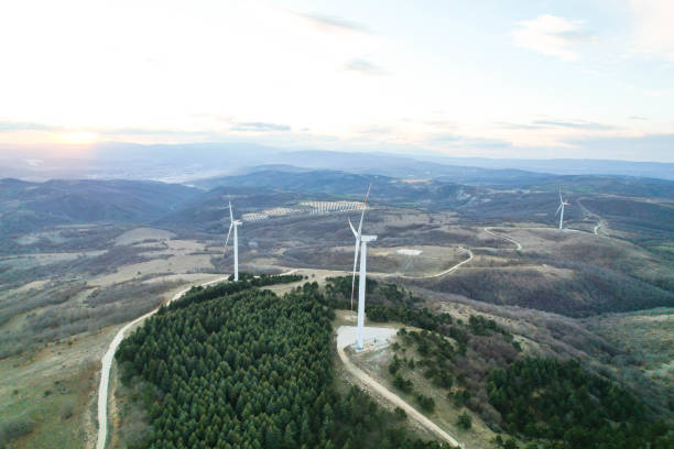 istock solar panels and wind turbines at sunset. renewable energy sources 1458578450
