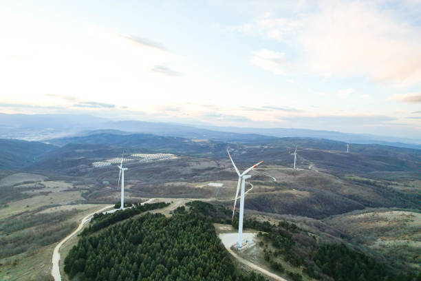 istock solar panels and wind turbines at sunset. renewable energy sources 1458579088