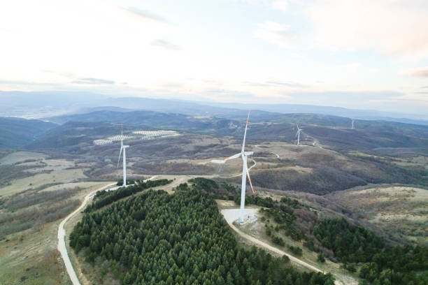 istock solar panels and wind turbines at sunset. renewable energy sources 1458579092