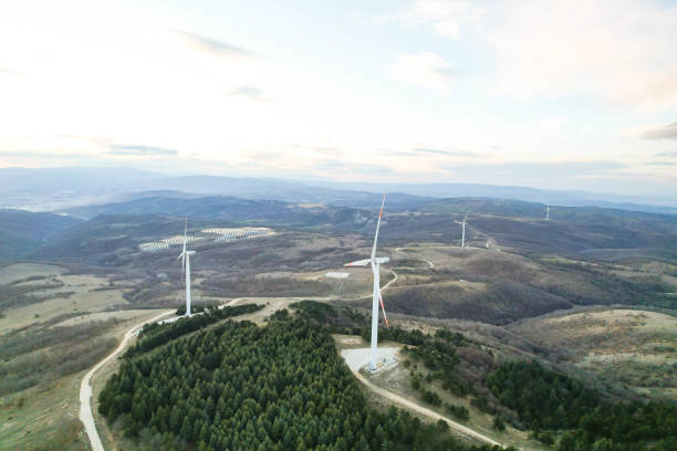 istock solar panels and wind turbines at sunset. renewable energy sources 1458579171