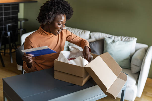 istock A smiling woman is opening a delivery box 1458579982