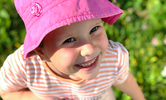 cute baby girl wearing  an oversized hat