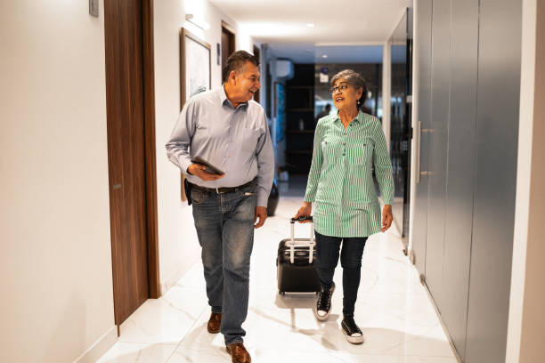 istock Coworkers walking with a suitcase at hotel 1458590017