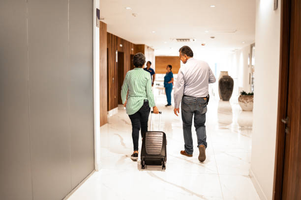 istock Coworkers walking with a suitcase at hotel 1458590021