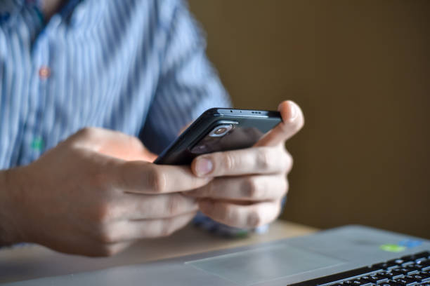 istock Men's hands and smartphone 1458590492