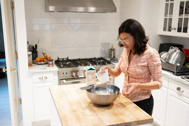 istock Latin woman making a cake at home 1458592646