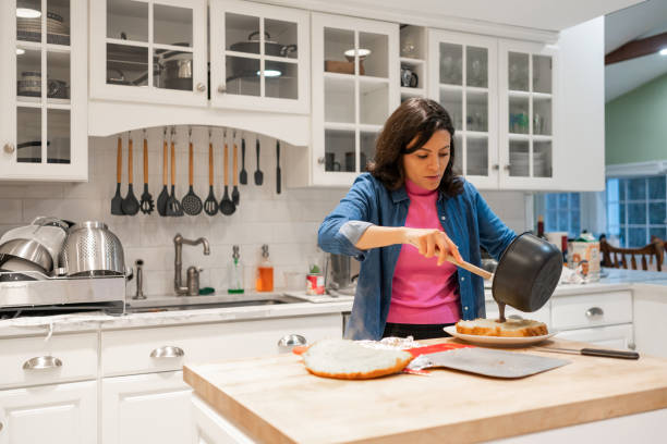 istock Latin woman making a cake at home 1458592690
