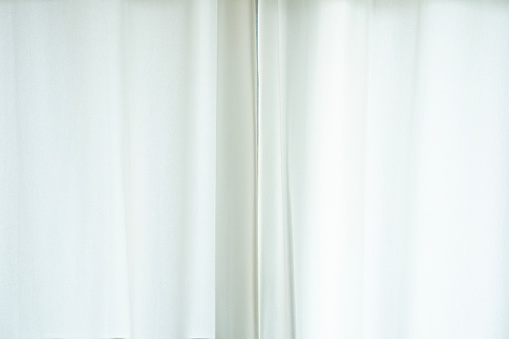 close up of white curtain in the room at home with sunlight