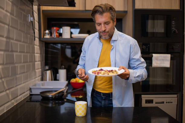 istock Man preparing food at kitchen 1458596640