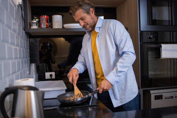 istock Man preparing food at kitchen 1458597231