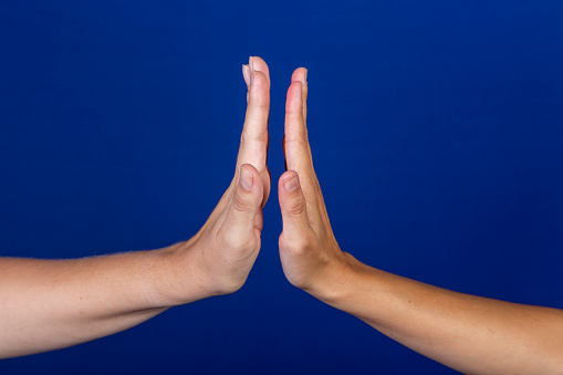 human hands clapping on blue background