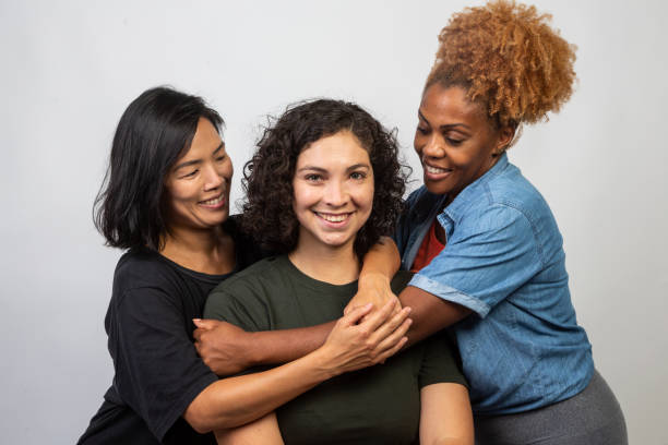 istock Women of various ethnicities embracing 1458598747