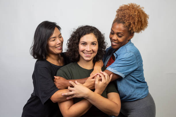 istock Women of various ethnicities embracing 1458598770
